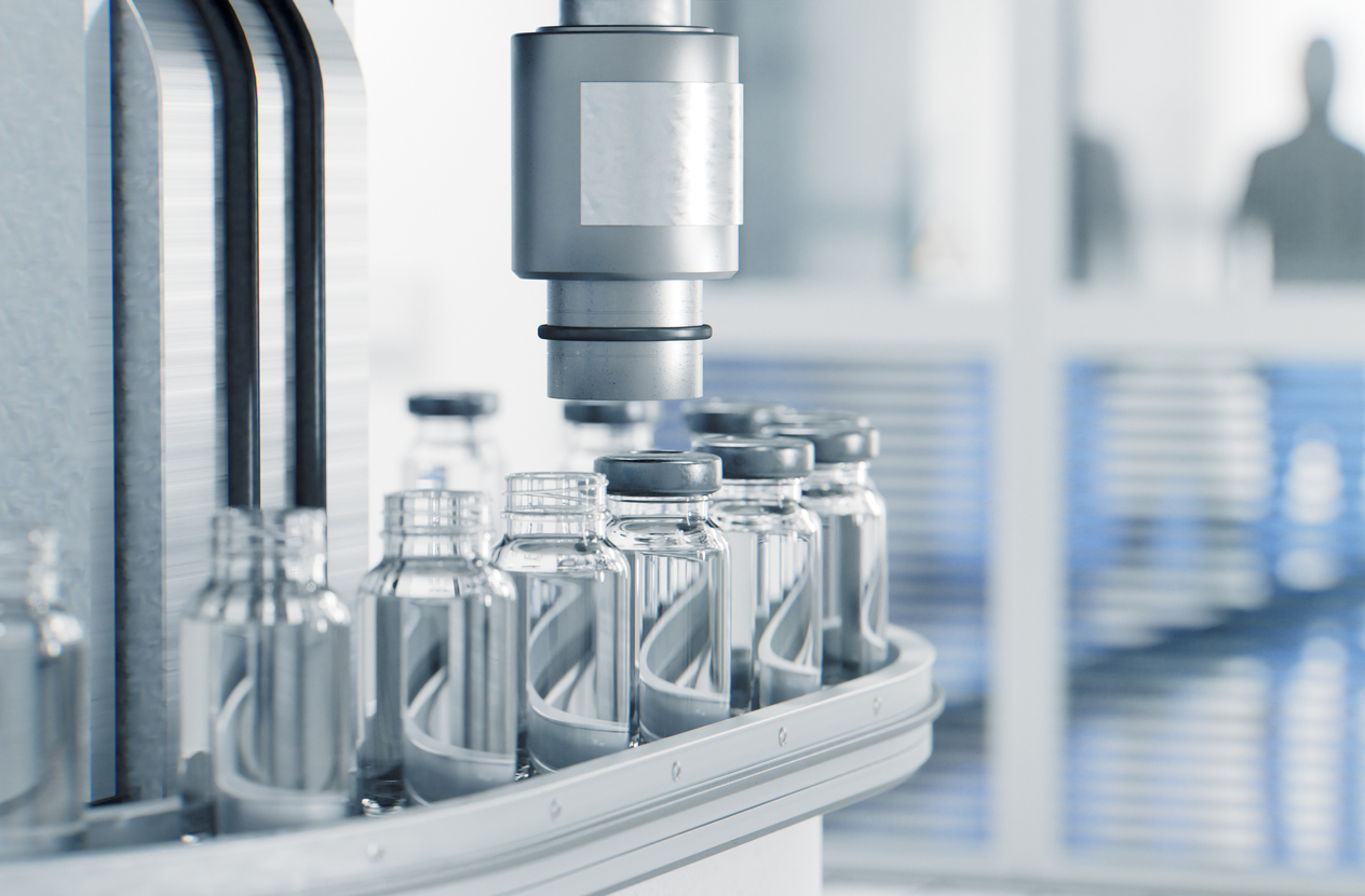Seals being applied to pre-sterilized glass vials on a manufacturing line