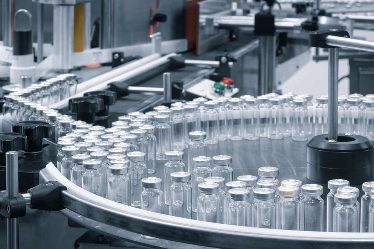 Vials on a conveyor belt during the sterile injectable filling process