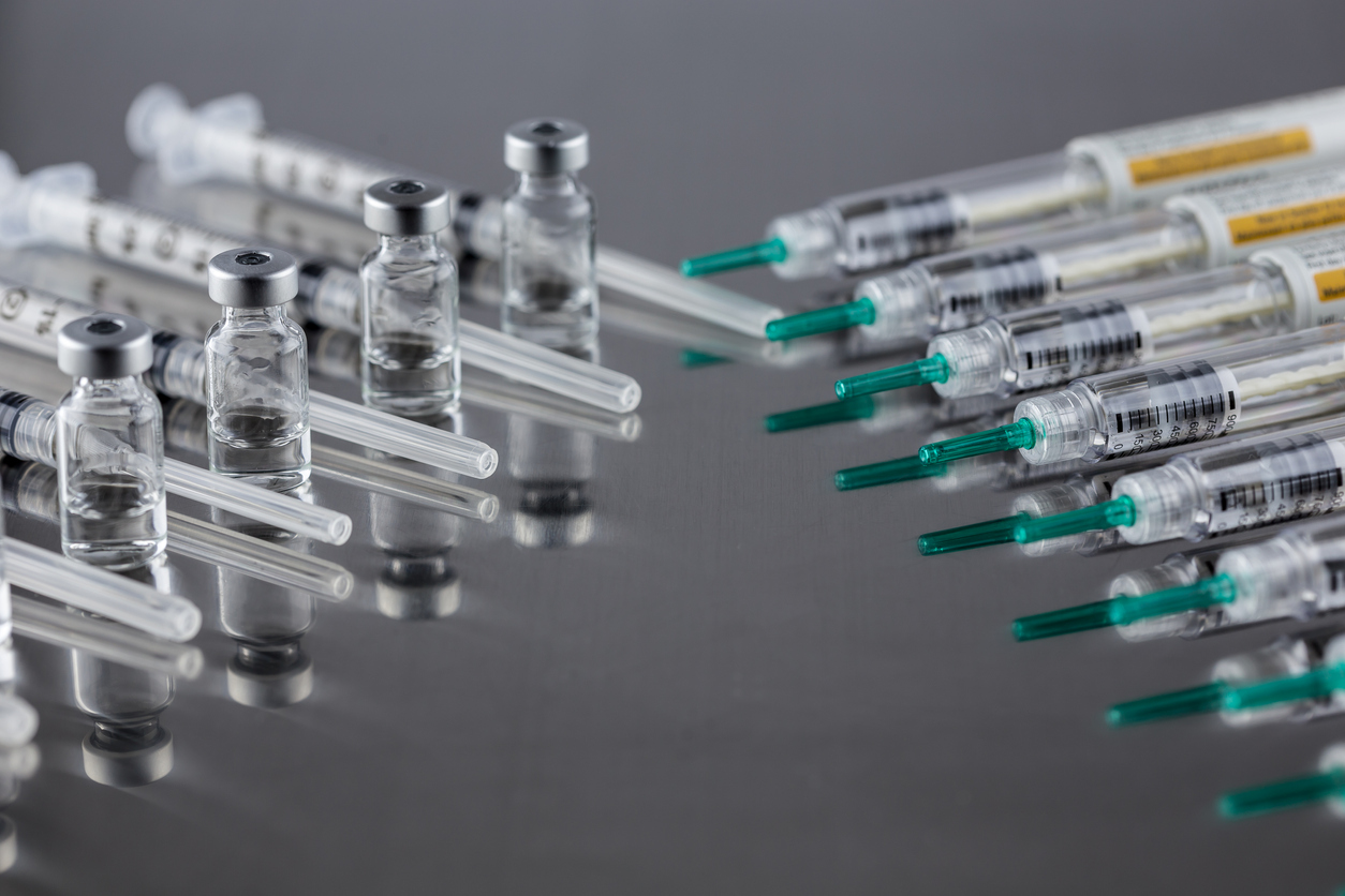 Injectable medication with syringes on table.
